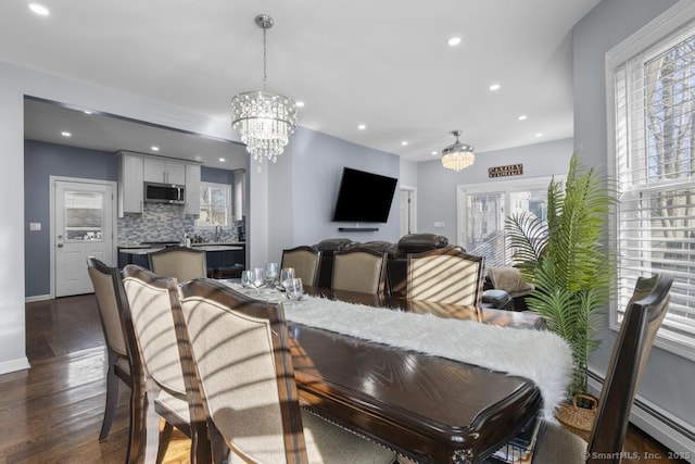 dining space with an inviting chandelier and dark hardwood / wood-style floors