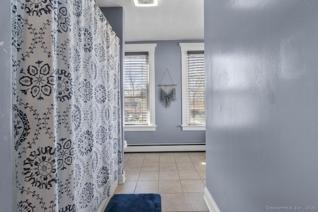 bathroom featuring a baseboard radiator, tile patterned floors, toilet, and curtained shower