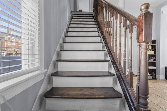 staircase featuring tile patterned floors