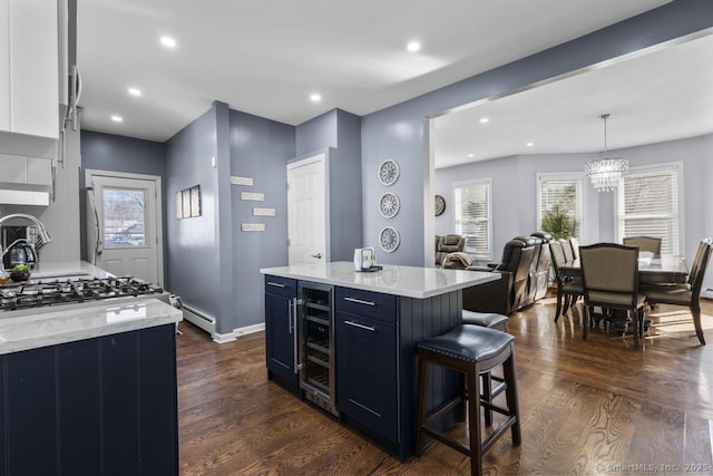 kitchen featuring pendant lighting, dark hardwood / wood-style floors, a center island, and white cabinets