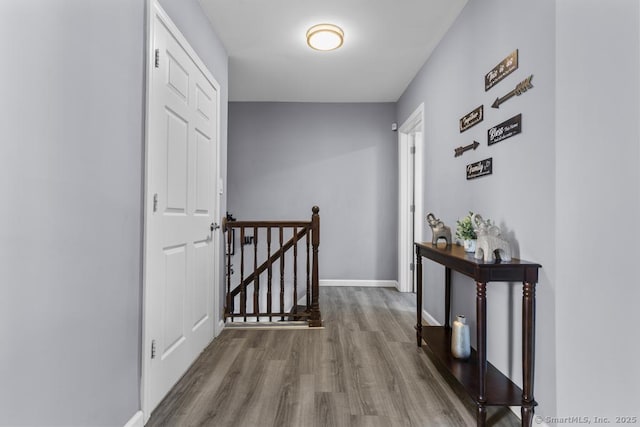 corridor with hardwood / wood-style floors