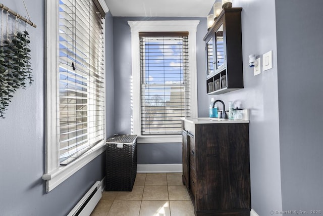 bathroom with vanity, a baseboard heating unit, and tile patterned floors