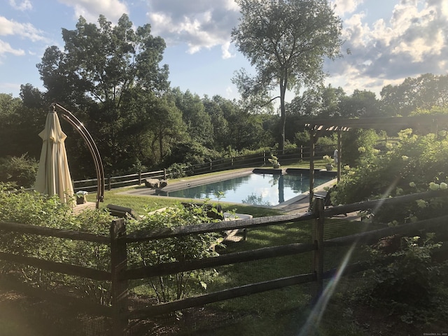 view of swimming pool featuring fence and a fenced in pool