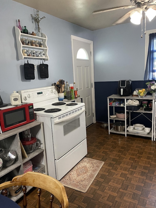 kitchen with dark parquet floors, white electric stove, and ceiling fan