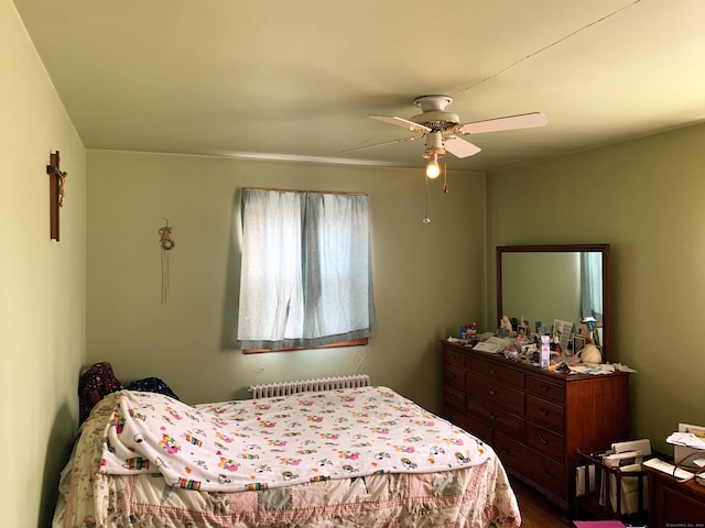 bedroom featuring radiator heating unit and ceiling fan