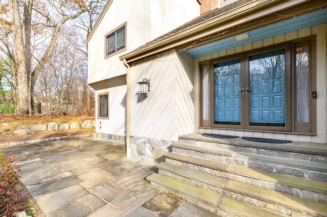 property entrance featuring a patio and french doors