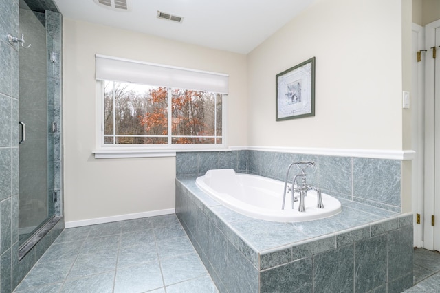 bathroom featuring tile patterned flooring and shower with separate bathtub