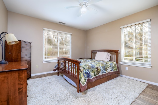 bedroom with hardwood / wood-style flooring and ceiling fan