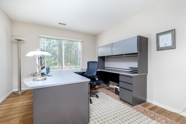 office with hardwood / wood-style flooring