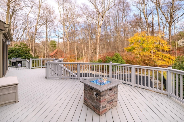 deck featuring area for grilling and an outdoor fire pit