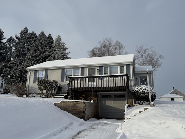 view of front facade with a wooden deck and a garage