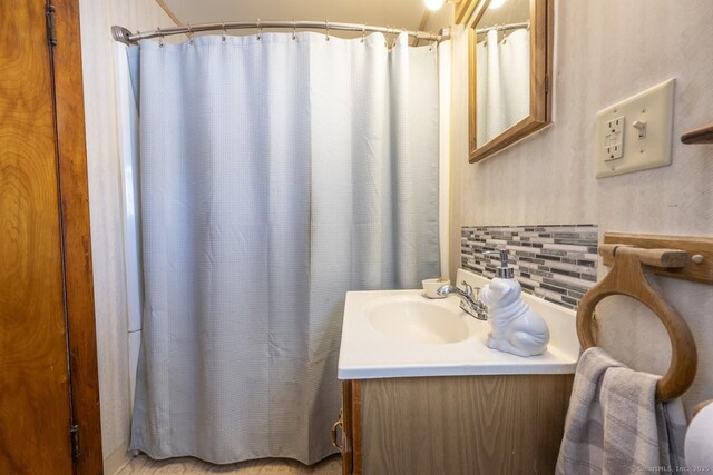 bathroom featuring vanity and curtained shower