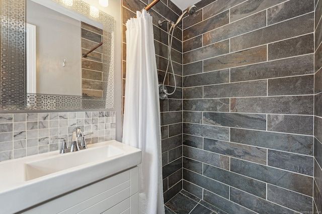 bathroom with tile walls, sink, tasteful backsplash, and curtained shower