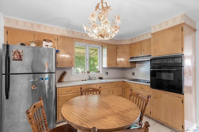 kitchen with light tile patterned flooring, sink, a chandelier, pendant lighting, and black appliances