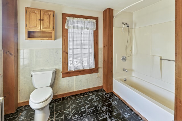 bathroom with shower / washtub combination, toilet, tile walls, and radiator heating unit