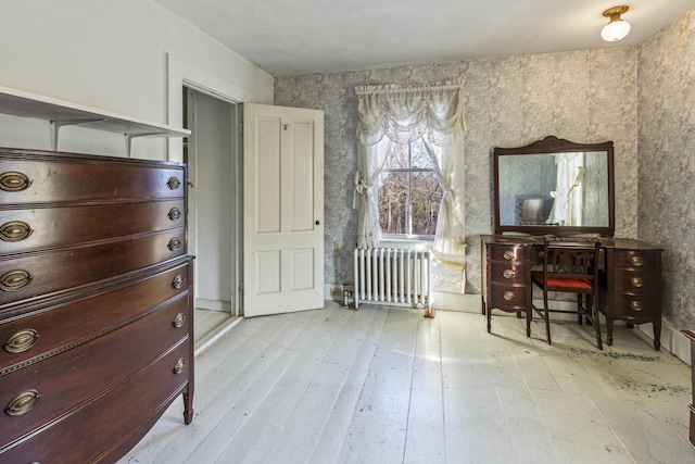 living area featuring radiator heating unit and light wood-type flooring