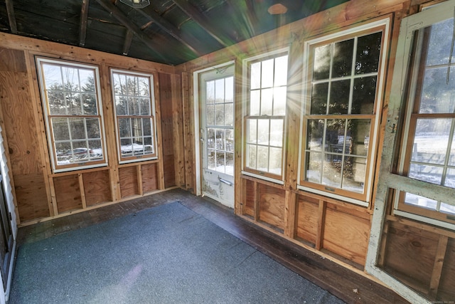 unfurnished sunroom with lofted ceiling