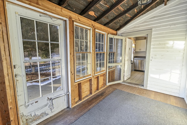 unfurnished sunroom featuring lofted ceiling