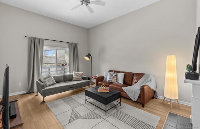 living room with light hardwood / wood-style floors and ceiling fan