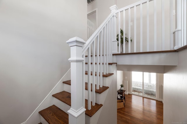 stairs featuring hardwood / wood-style flooring