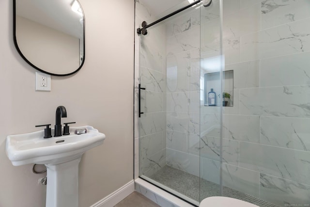 bathroom featuring an enclosed shower and toilet