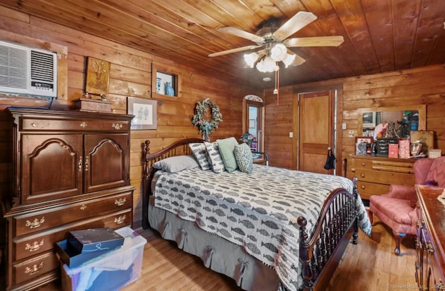 bedroom featuring wood ceiling, a wall mounted AC, light hardwood / wood-style flooring, and wood walls