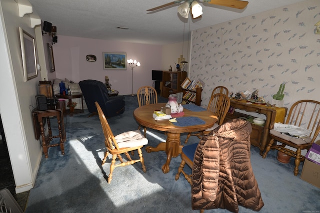 dining area with ceiling fan and carpet