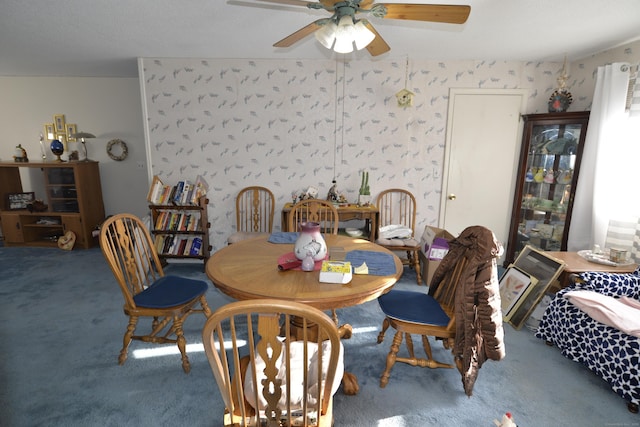 carpeted dining room with ceiling fan