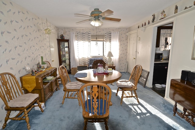 dining space with carpet and ceiling fan