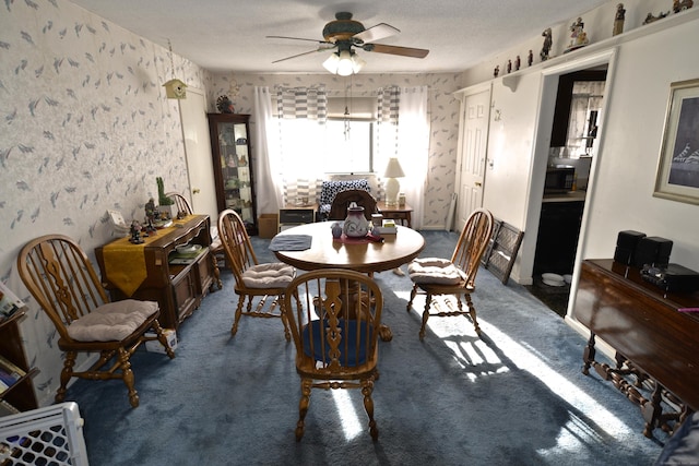 carpeted dining area with ceiling fan and a textured ceiling