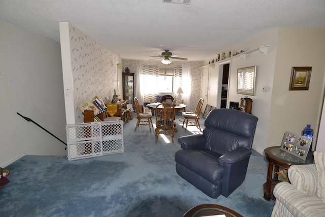 living room featuring ceiling fan and a textured ceiling