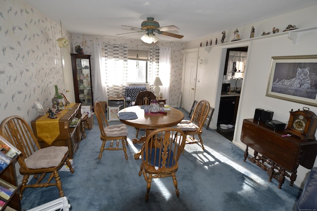 carpeted dining space featuring ceiling fan