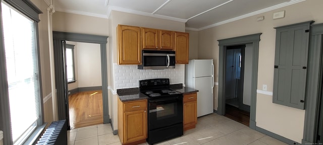 kitchen featuring decorative backsplash, black electric range, ornamental molding, and white refrigerator