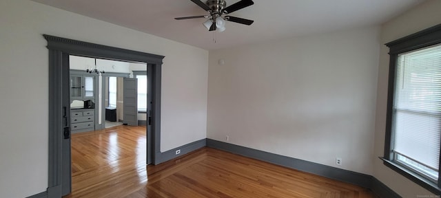 empty room with hardwood / wood-style flooring and ceiling fan