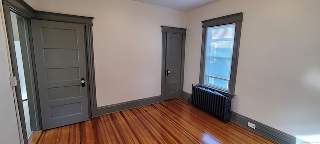 interior space featuring wood-type flooring and radiator