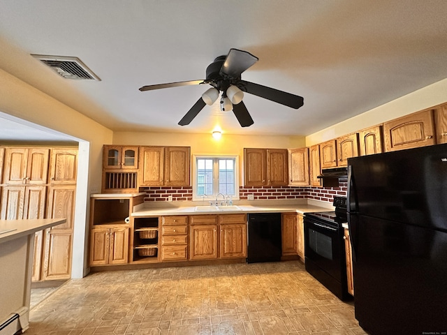 kitchen with sink, ceiling fan, tasteful backsplash, black appliances, and a baseboard radiator