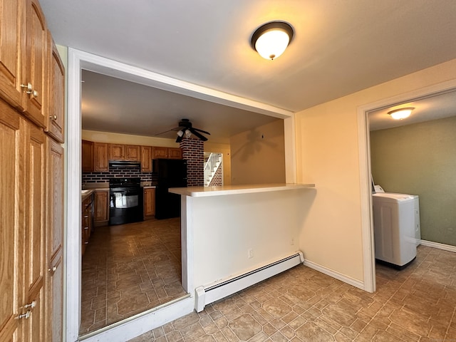 kitchen with black appliances, washer / dryer, decorative backsplash, baseboard heating, and kitchen peninsula