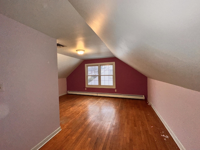 bonus room with a baseboard radiator, dark hardwood / wood-style floors, and vaulted ceiling