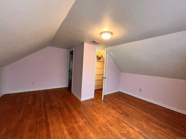 bonus room with hardwood / wood-style flooring and lofted ceiling