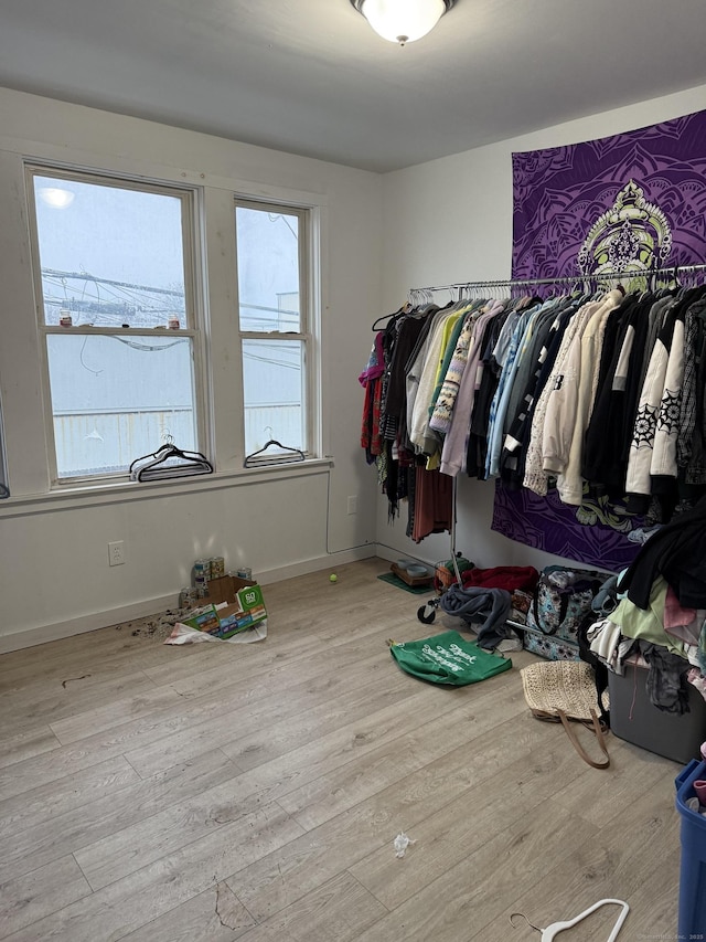 walk in closet featuring light hardwood / wood-style flooring