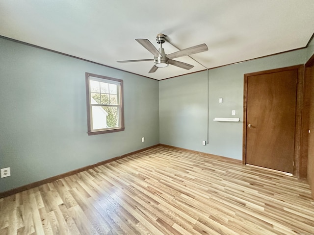 spare room with crown molding, light hardwood / wood-style floors, and ceiling fan