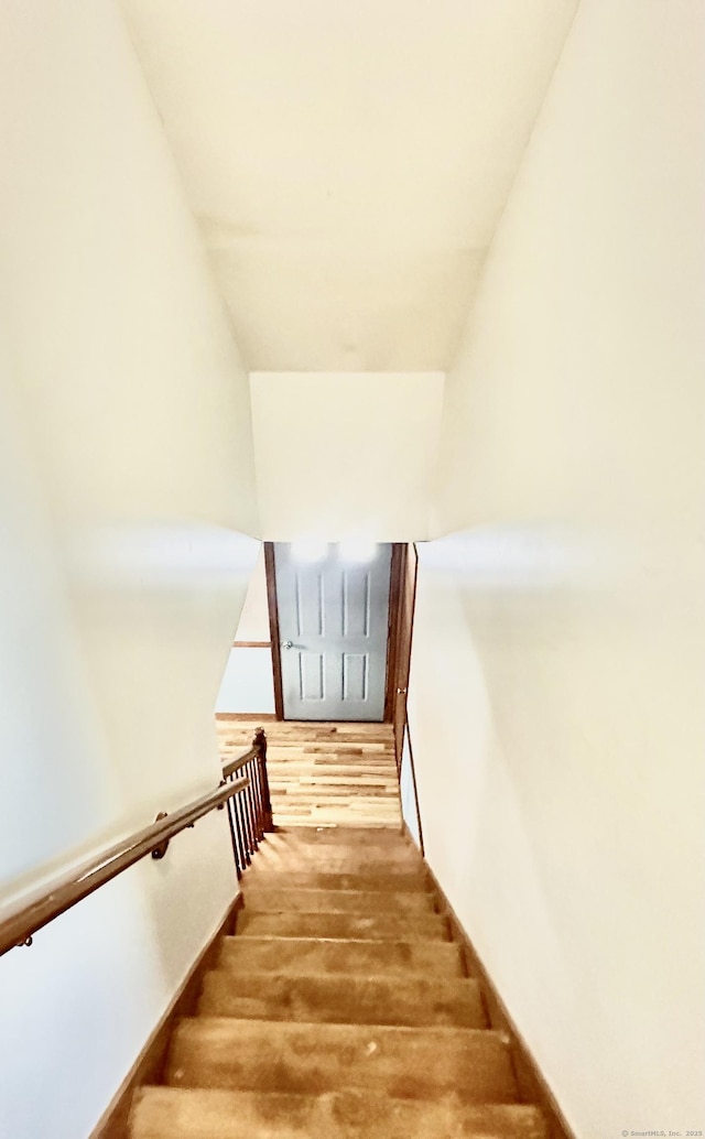 stairs featuring hardwood / wood-style flooring