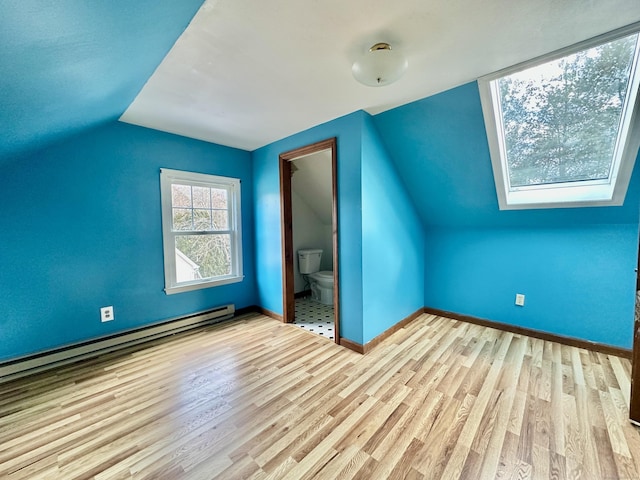 bonus room featuring lofted ceiling, light hardwood / wood-style floors, and baseboard heating