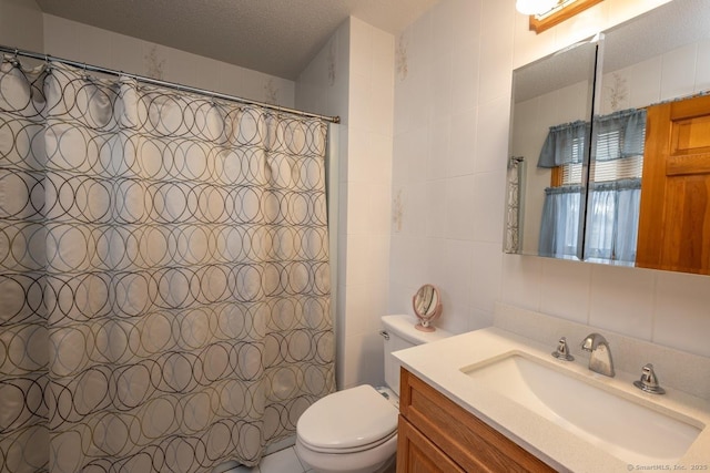 bathroom featuring tile walls, a shower with shower curtain, vanity, a textured ceiling, and toilet