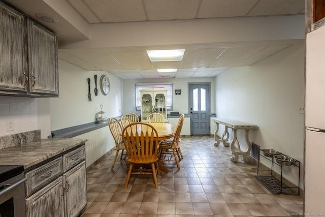 dining area featuring a drop ceiling