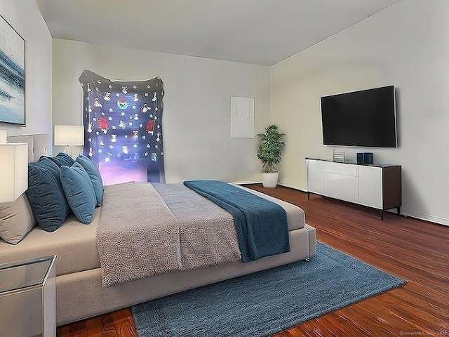 bedroom with dark hardwood / wood-style floors