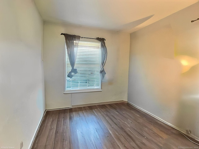 empty room featuring dark hardwood / wood-style flooring