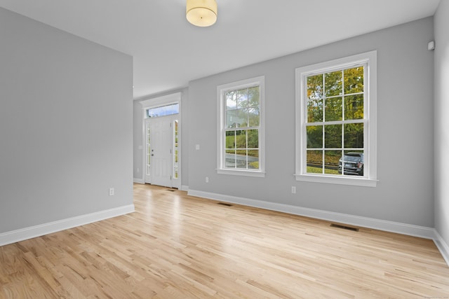 empty room with light hardwood / wood-style flooring