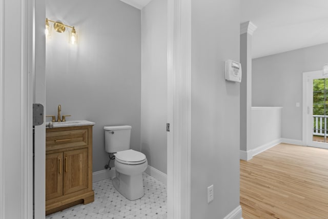 bathroom featuring vanity, hardwood / wood-style flooring, and toilet