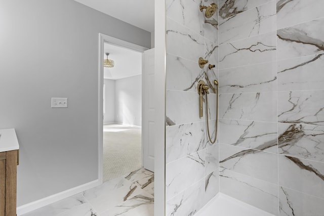 bathroom with vanity and a tile shower